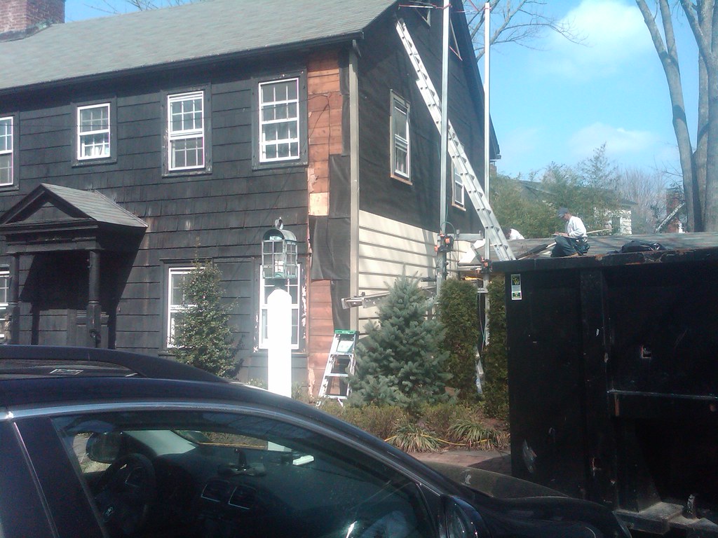 Professional team collaborating on exterior renovation work