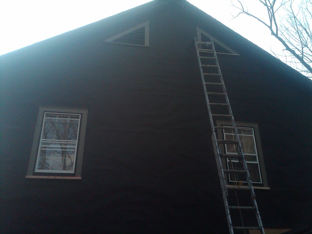 Professional team executing exterior renovation work with precision